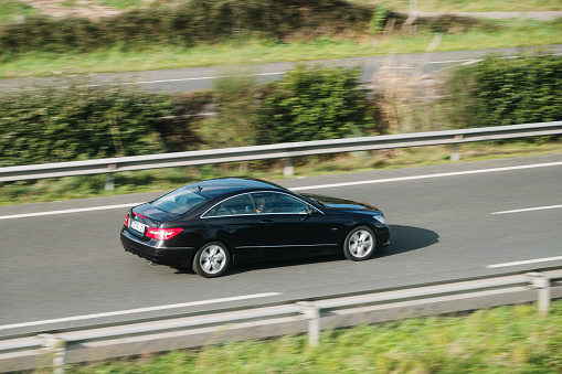 Santander, Spain - 12 February 2024: A Mercedes-Benz E Class Coupe in motion on a highway