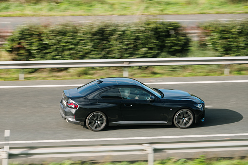 Santander, Spain - 12 February 2024: A BMW 2 Series Coupe in motion on a highway