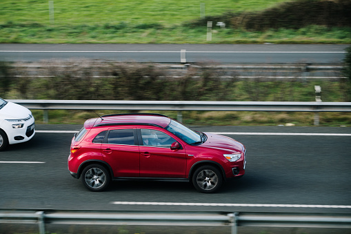 Santander, Spain - 12 February 2024: A Mitsubishi ASX in motion on a highway