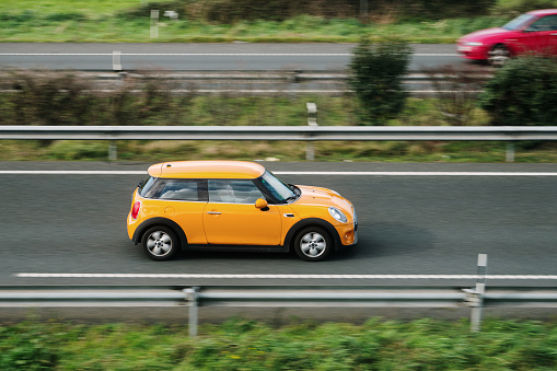 Santander, Spain - 12 February 2024: A Mini Cooper in motion on a highway