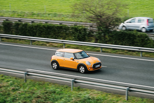 Santander, Spain - 12 February 2024: A Mini Cooper in motion on a highway