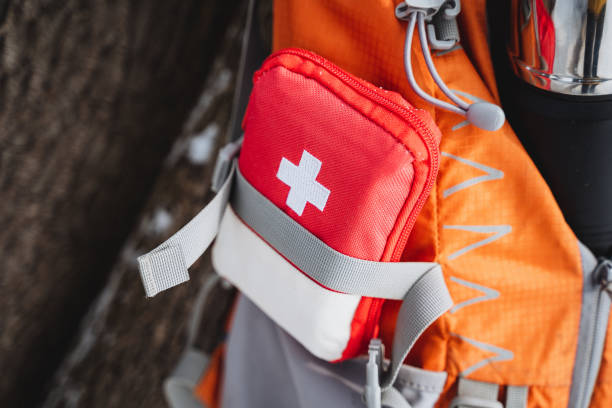 istock Red and white first aid kit attached to backpack, ideal for travel, hiking, camping. 2007866299