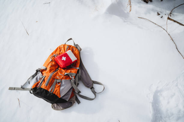 istock Orange backpack with first aid kit in snowy landscape, isolated on white background 2007866309
