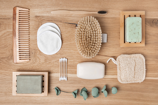 Zero waste beauty and spa products, sustainable bathroom and eco-friendly lifestyle and home. Bamboo toothbrush, organic soap, cotton swabs and make-up pads, wood brush and comb.