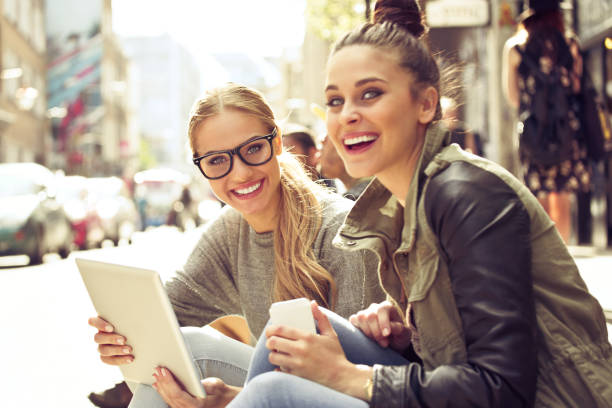 istock Young women using digital tablet in the city 2007876968