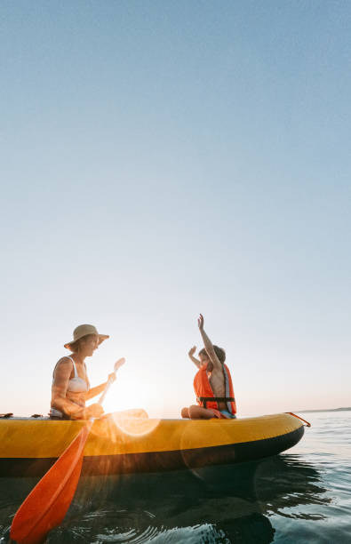 Mother and son kayaking together