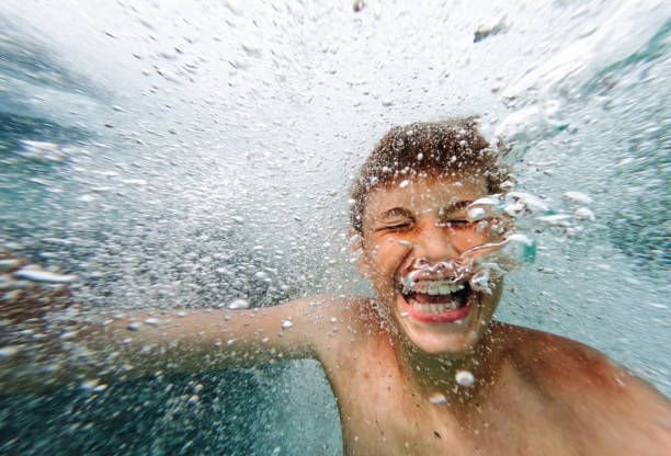 Photo of a young boy diving in the sea