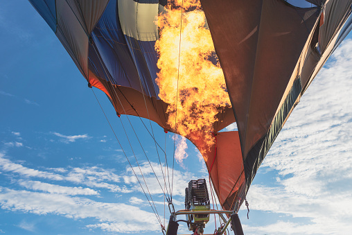 Hot air balloon with flame. Closeup.hot air balloon as it takes you on an adventure over the earth.Close-up of hot air balloon burner at golden hour,outdoors shot.