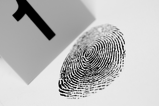 Black fingerprint with a crime scene marker