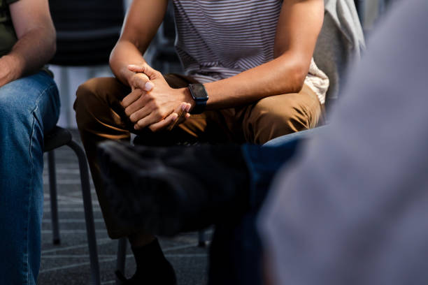 istock Unrecognizable young man clasps his hands while sitting in the group meeting 2007949298