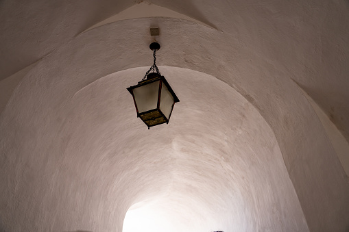 Sintra, Portugal - Oct. 3, 2023: Ancient chandelier in corridor in Pena Palace - Palácio Nacional da Pena, Sintra, Portugal.