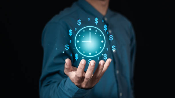 istock Time management concept, businessman holding clock and money icon on interface virtual for business time management. time is money, work planning increases efficiency and reduces work time. 2007969045