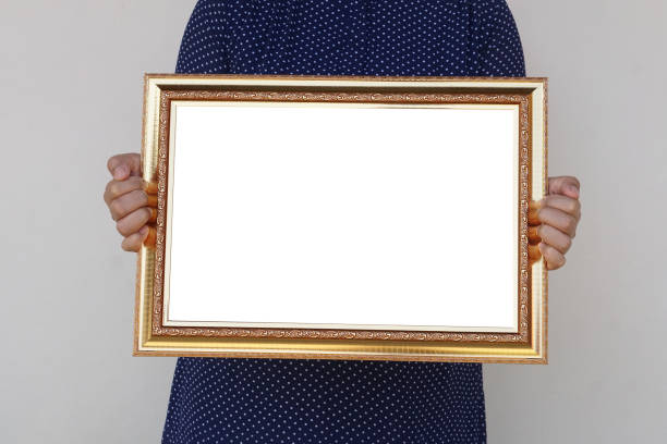 istock Closeup woman holds empty photo frame or blank diploma certificate frame. 2007974268