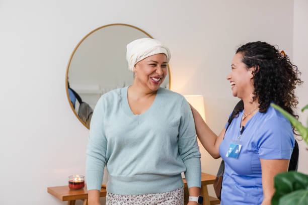 istock Mid adult female nurse smiles while visiting with her patient 2008011088