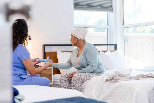 istock Female hospice nurse sits bedside with her patient 2008011123