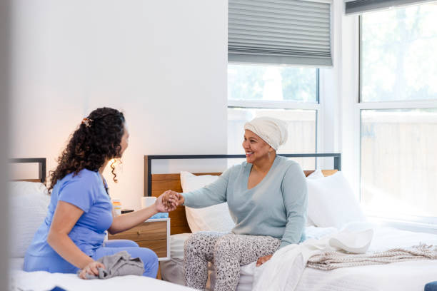 Female hospice nurse extends her hand to help her patient
