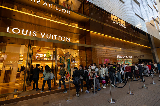 Hong Kong - February 13, 2024 : Shoppers queue at a Louis Vuitton store in the Canton Road, Tsim Sha Tsui, Kowloon, Hong Kong.