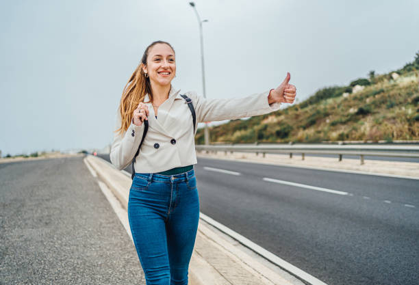 Young woman walking in the middle of a road.
