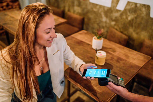 istock Woman paying with a smartphone 2008046672