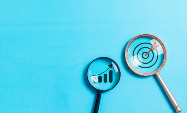 istock Magnifying glass focus to growth graph and target on blue background. business achievement goal and objective target concept. 2008050305