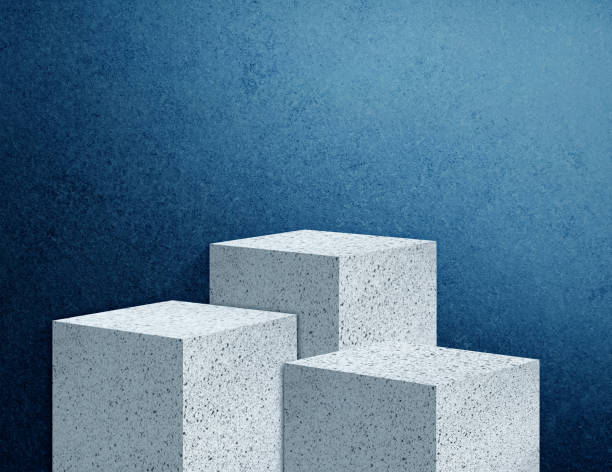 grey terrazzo stone podiums for product presentation mock up, stone stage for showing cosmetic product displayed with abstract blue grainy concrete wall as background, light from right above. - pedestal collection showing old imagens e fotografias de stock