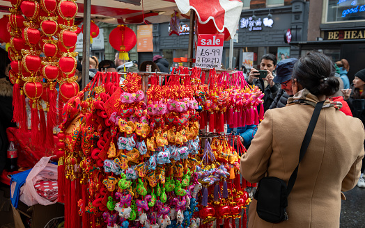 London. UK- 02.11.2024. Visitors and tourist to the Chinese New Year celebration in China Town buying beautiful new year ornaments and decoration from a stall.