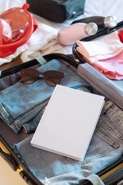 istock opened packed suitcase on bed in hotel room 2008066202