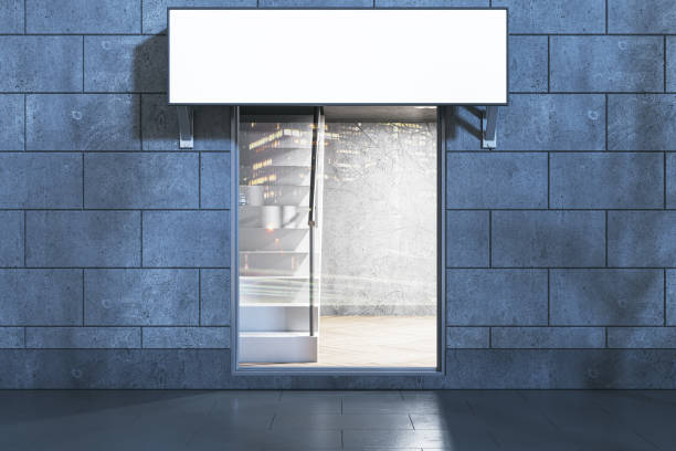 istock Modern nighttime glass storefront in concrete tile building with empty white mock up stopper and tree shadows. 3D Rendering. 2008091190