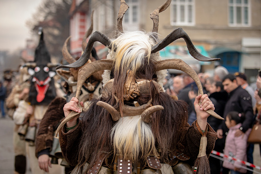 Kyustendil, Bulgaria - February 10, 2024: First edition of a masquerade festival in Kyustendil Bulgaria. Men dressed in a traditional Kuker leather suit with brass bells dance and perform a ritual of fertility and health.