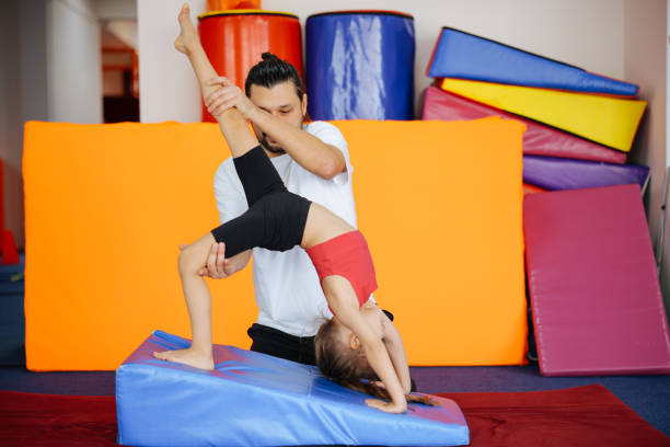 Cute active child girl in sensory integration room, kindergarten. Kid is active leisure. Childhood and sporty lifestyle.Sports weekend in gymnastic center. Fitness,healthy, develop skills concept