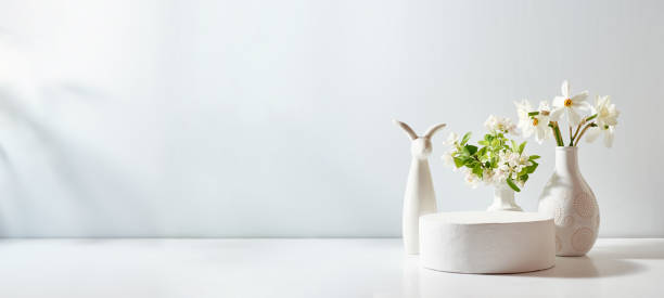 istock Empty round white podium for product presentation and spring flowers on a light background. Mockup concept with copy space 2008151601