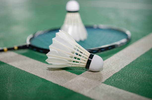 istock Badminton rackets and white cream badminton shuttlecocks after playing or after games on green floor in indoor badminton court  soft focus  concept for badminton lovers around the world. 2008166364
