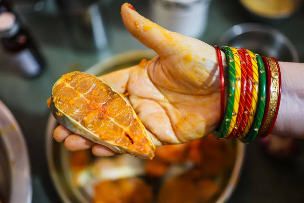 fresh fish marinating in spices at home in plat from different angle