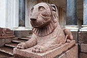 Granite lion at the entrance of The marble Voronikhin colonnades