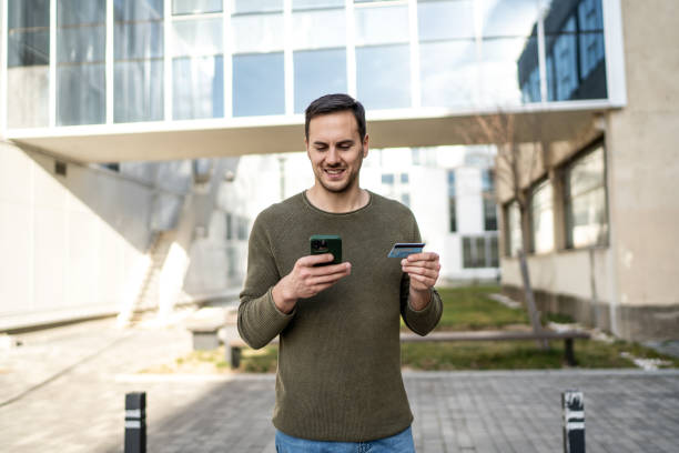 istock Handsome man using smart phone on city street 2008176354