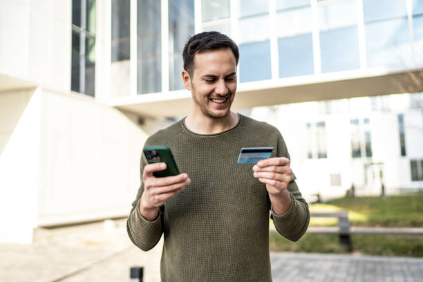 istock Handsome man using smart phone on city street 2008177457