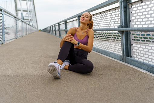 The rhythmic beat of running shoes on the bridge comes to a sudden pause when a young woman sustains an injury, turning a routine run into a moment of resilience and recovery