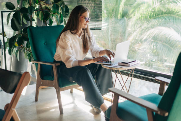 istock A young businesswoman freelancer works remotely online using a laptop while sitting in a cozy cafe. 2008216849