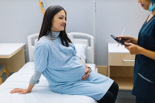 Pregnant woman having medical consultation at the gynaecologist clinic.