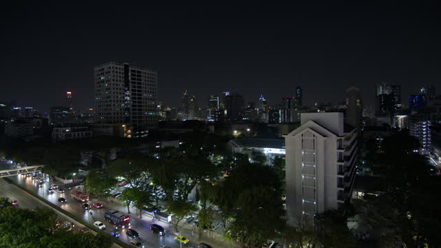 city at night, featuring tall buildings and urban scenery
