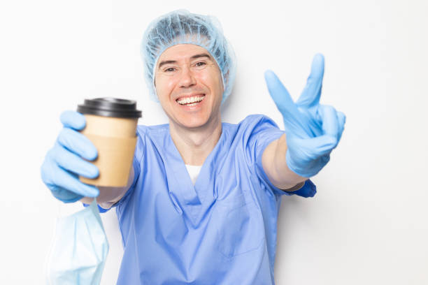 smiling doctor taking a coffee break during his shift at the hospital.daily routine of a medical worker.