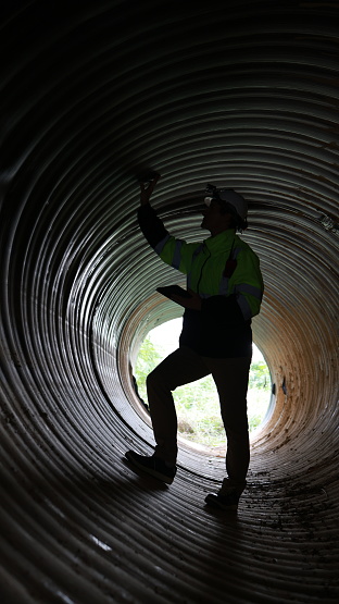 The Specialist infrastructure works at Modern water supply and sewerage systems. Underground pipeline works. Water supply and wastewater disposal of a residential city. Close-up of underground utilities