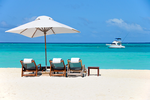 beach chairs and umbrella on beach