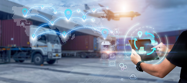 Man hands using tablet on blurred  Distribution Warehouse and Freight Truck