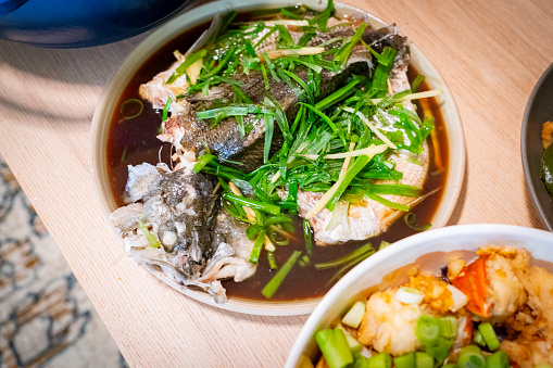 Chinese steamed whole sea bass on the table