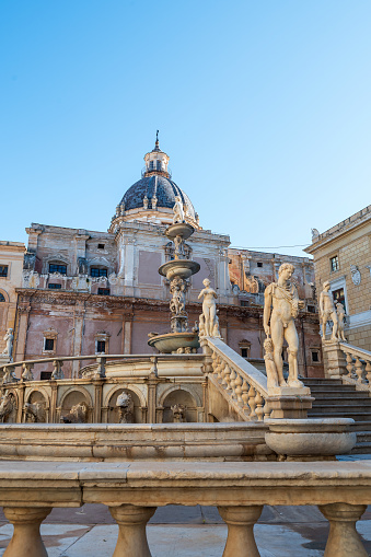 Ascending the grand stone stairs of Pretoria fountain, surrounded by classical statues and the stunning Palermo skyline, one is transported to a bygone era of opulence and architectural marvels in Italy