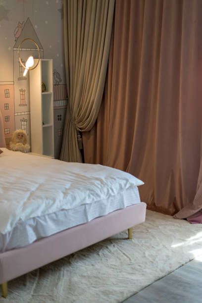 bedroom with heavy curtains and soft carpet