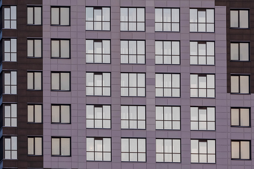 five rows of windows on the facade of a modern apartment building