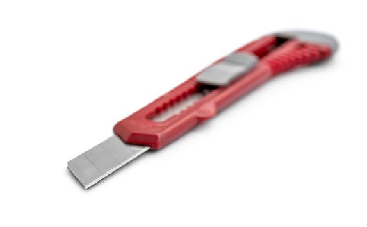 Red stationery knife on a white background.