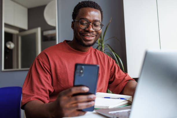 istock Young man looking at the phone. Technology at home 2008304257
